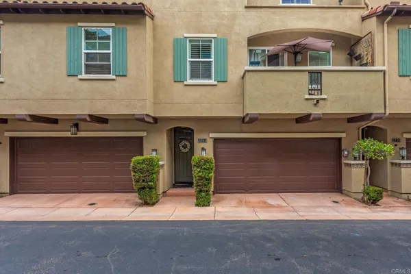 a front view of a house with a yard and a garage