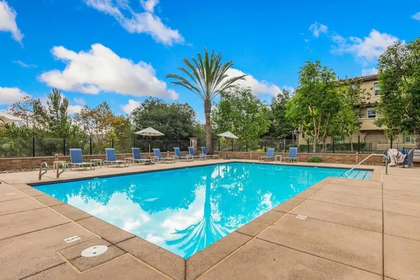 a view of swimming pool with outdoor seating and plants