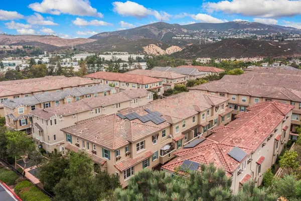 an aerial view of residential houses with outdoor space