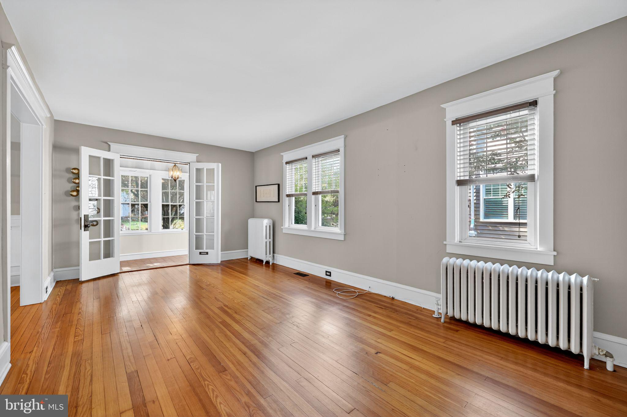 159 Wayne Avenue Haddonfield, NJ 08033 - Photo 13 of 30 a view of an empty room with wooden floor and a window