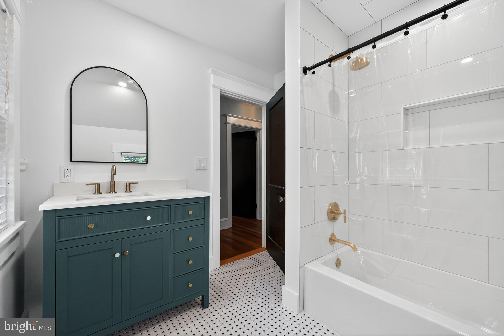 159 Wayne Avenue Haddonfield, NJ 08033 - Photo 20 of 30 a bathroom with a tub sink and mirror