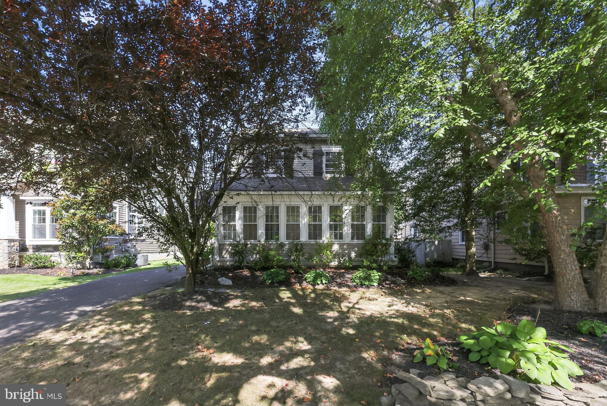 159 Wayne Avenue Haddonfield, NJ 08033 - Photo 3 of 30 a view of a brick house next to a yard with large trees