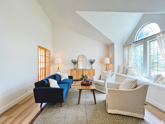 12169 Hidden Valley Road, Unit 44 Sandy, UT 84092 - Photo 8 of 49 Vaulted ceilings, wood-finish flooring, arched window, built-in window seating, and interior French doors