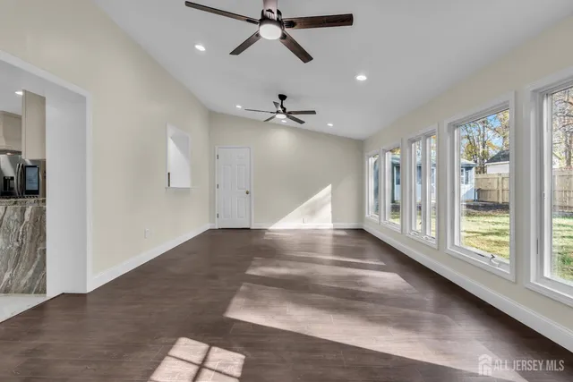 a view of staircase with wooden floor and white walls