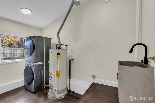 a view of a big room with wooden floor a ceiling fan and windows