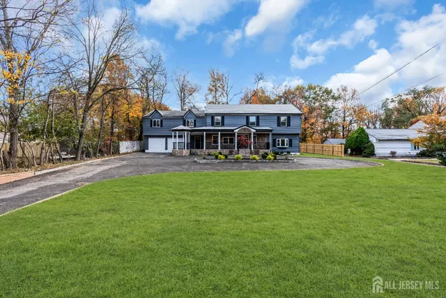 a front view of a house with garden and porch
