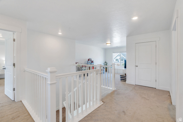 646 South Meade Street Mapleton, UT 84664 - Photo 13 of 46 Upper-level landing featuring a white painted railing and neutral carpeting