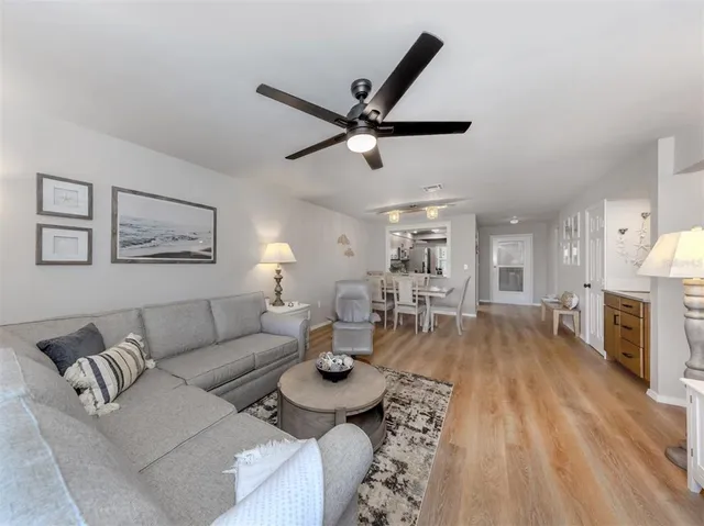 a living room with fireplace furniture and a wooden floor