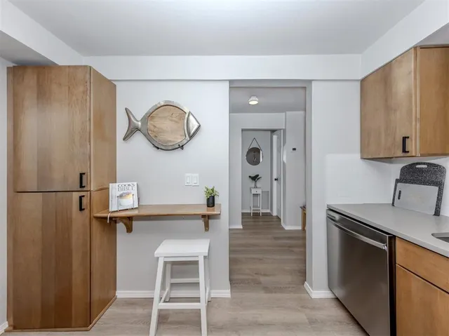 a kitchen with a refrigerator and a sink