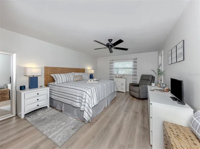 a spacious bedroom with a bed and a couch