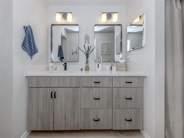 a bathroom with a double vanity sink mirror and vanity