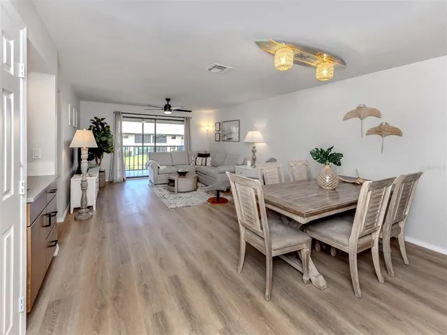 a view of a dining room with furniture and wooden floor