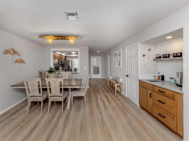 a dining room with furniture and wooden floor