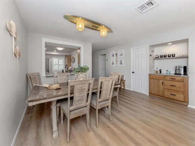a dining room with furniture and wooden floor