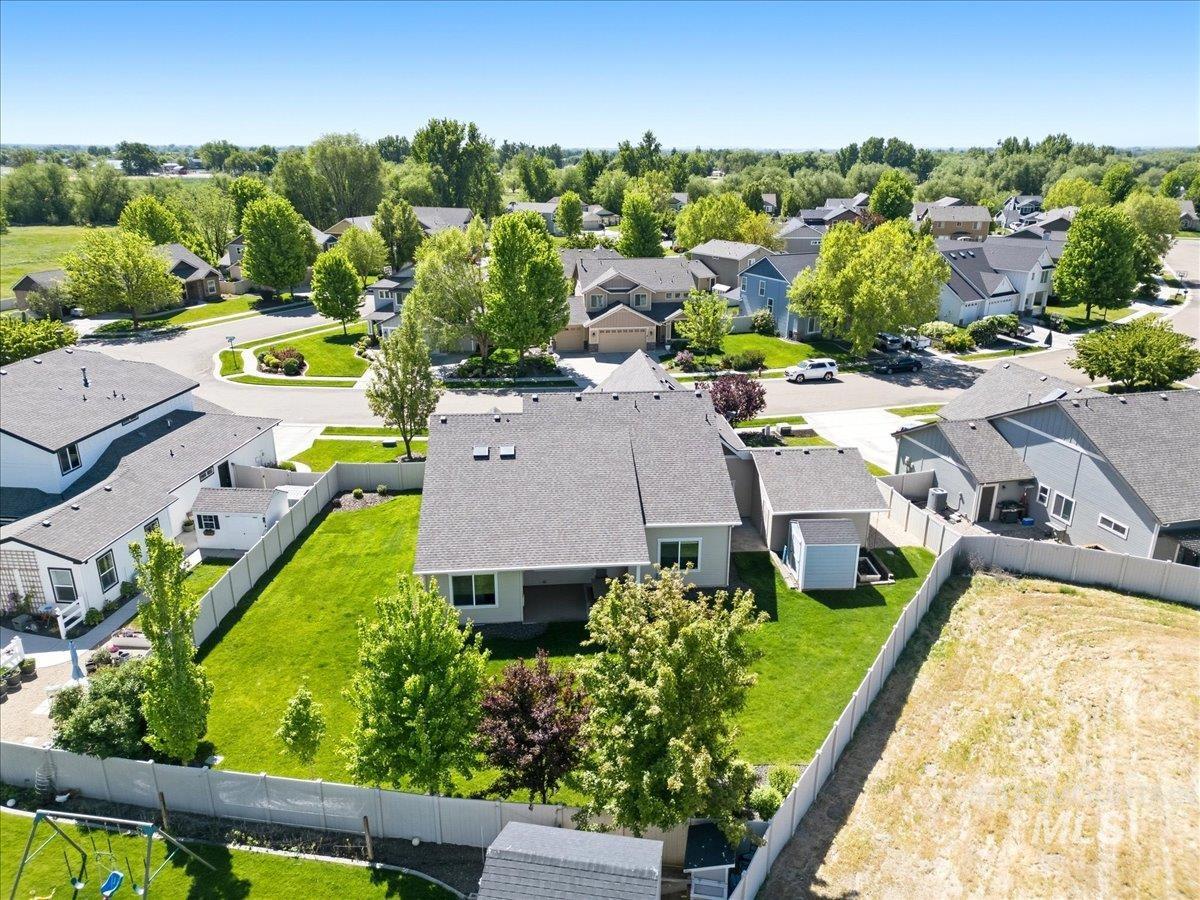 1183 North Buffalo Way Middleton, ID 83644 - Photo 4 of 47 Expansive backyard featuring a manicured lawn, established trees, and a privacy fence