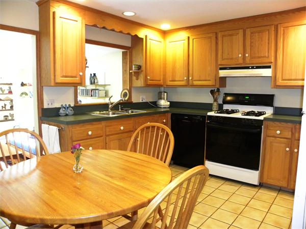 63 High Plain Road Andover, MA 01810 - Photo 3 of 15 a kitchen with stainless steel appliances granite countertop a sink a stove a counter space and cabinets