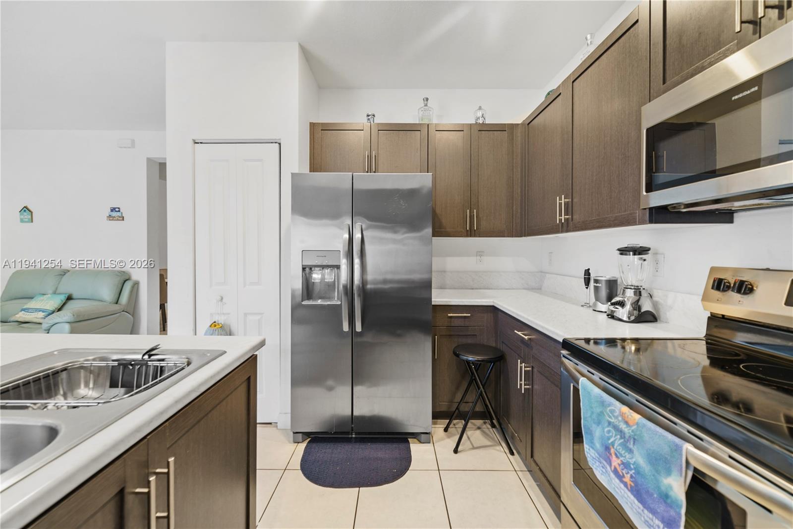 11805 Southwest 245 Terrace Homestead, FL 33032 - Photo 13 of 37 a kitchen with stainless steel appliances granite countertop a sink stove and refrigerator