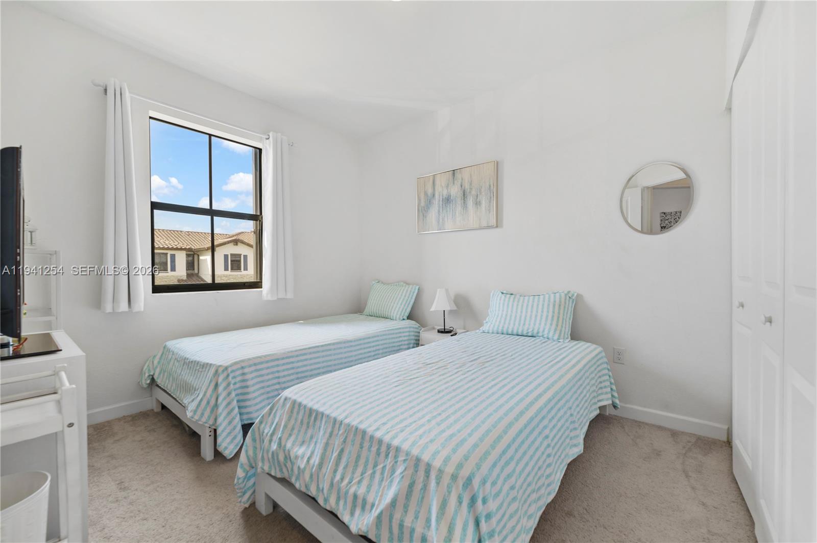 11805 Southwest 245 Terrace Homestead, FL 33032 - Photo 20 of 37 a bedroom with two beds and a window
