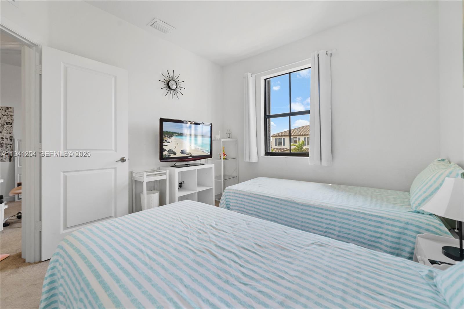 11805 Southwest 245 Terrace Homestead, FL 33032 - Photo 21 of 37 a bedroom with a bed and a flat screen tv