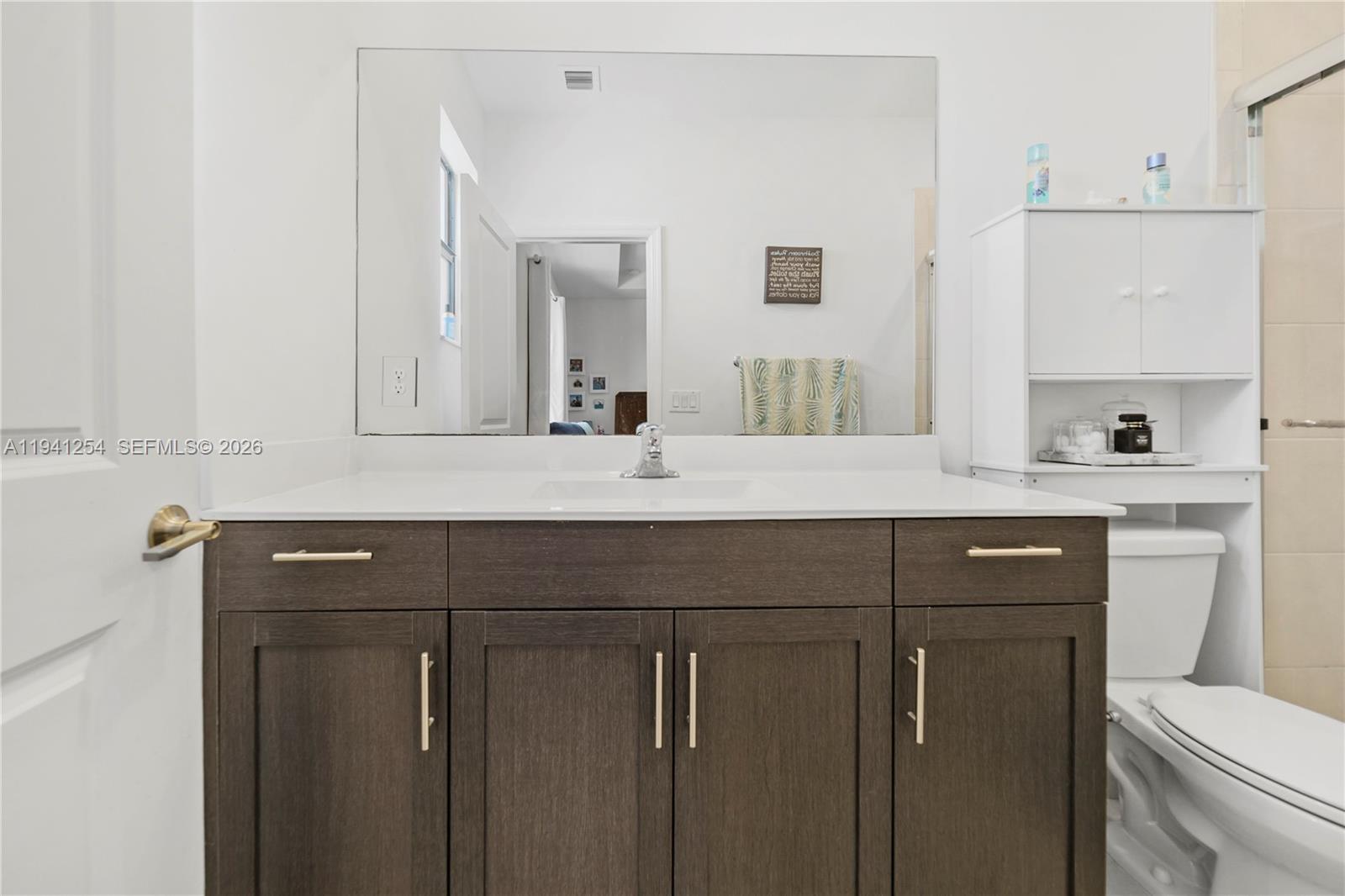 11805 Southwest 245 Terrace Homestead, FL 33032 - Photo 27 of 37 a bathroom with a double vanity sink and mirror