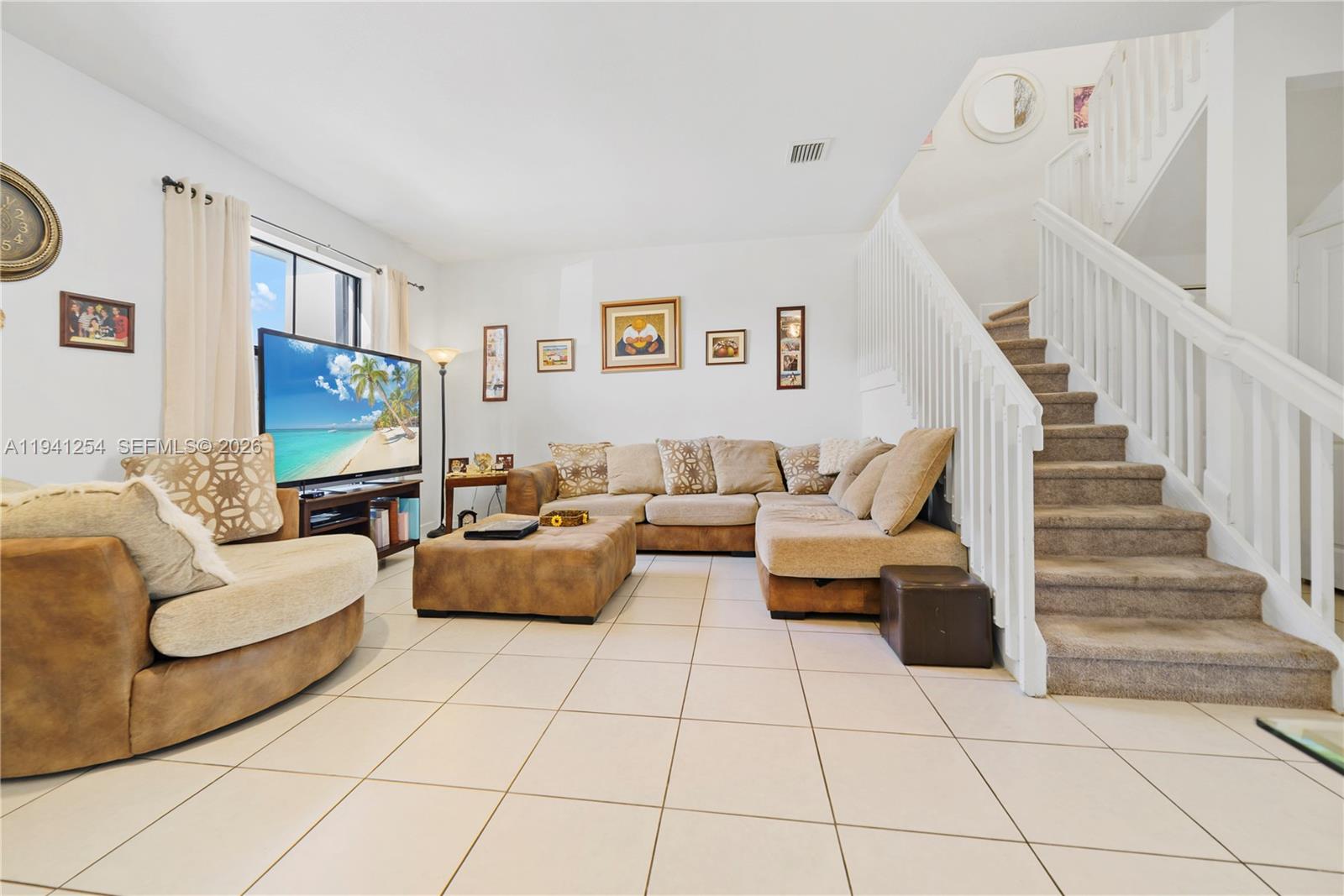 11805 Southwest 245 Terrace Homestead, FL 33032 - Photo 4 of 37 a living room with furniture and a flat screen tv