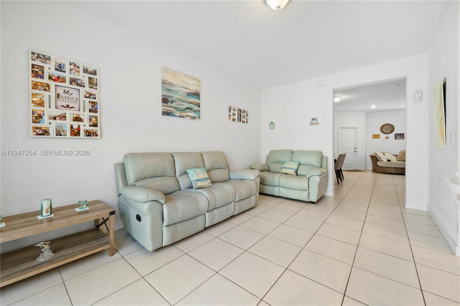 11805 Southwest 245 Terrace Homestead, FL 33032 - Photo 9 of 37 a living room with furniture and painting on the wall