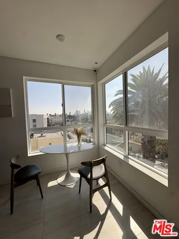 a view of a room with gym equipment and a flat screen tv