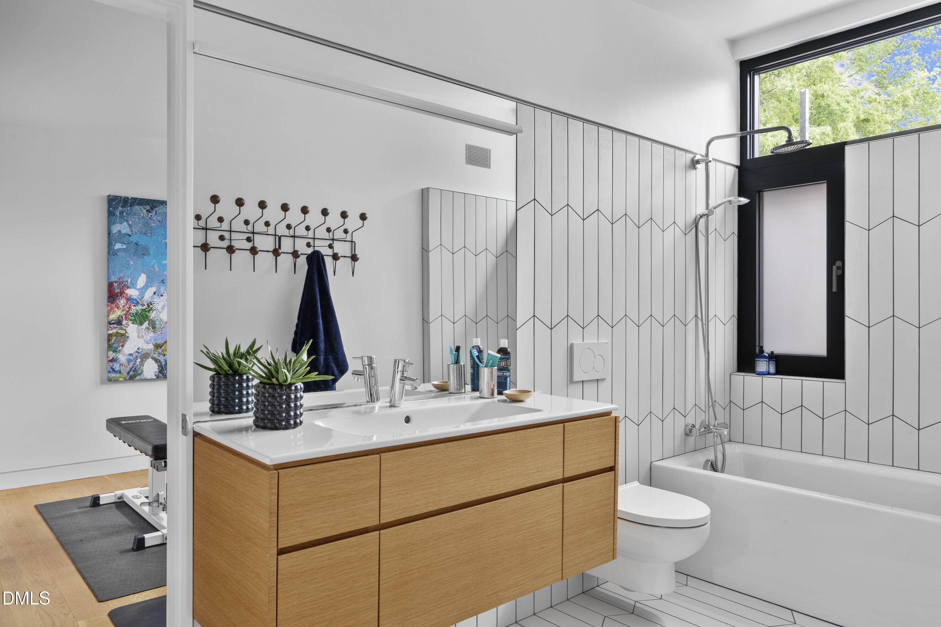 924 Tower Street Raleigh, NC 27607 - Photo 29 of 32 a bathroom with a double vanity sink toilet and shower