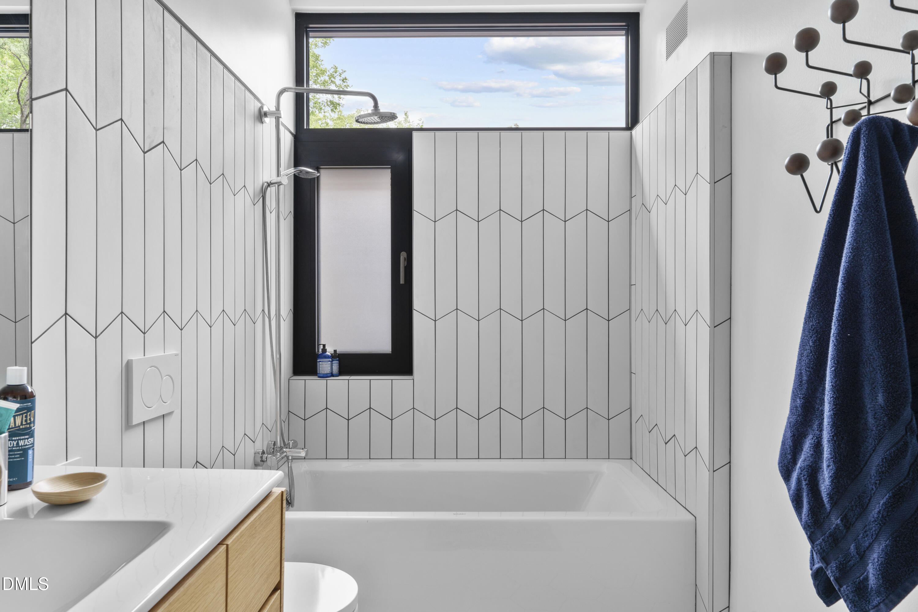 924 Tower Street Raleigh, NC 27607 - Photo 30 of 32 a bathroom with a sink a toilet and shower