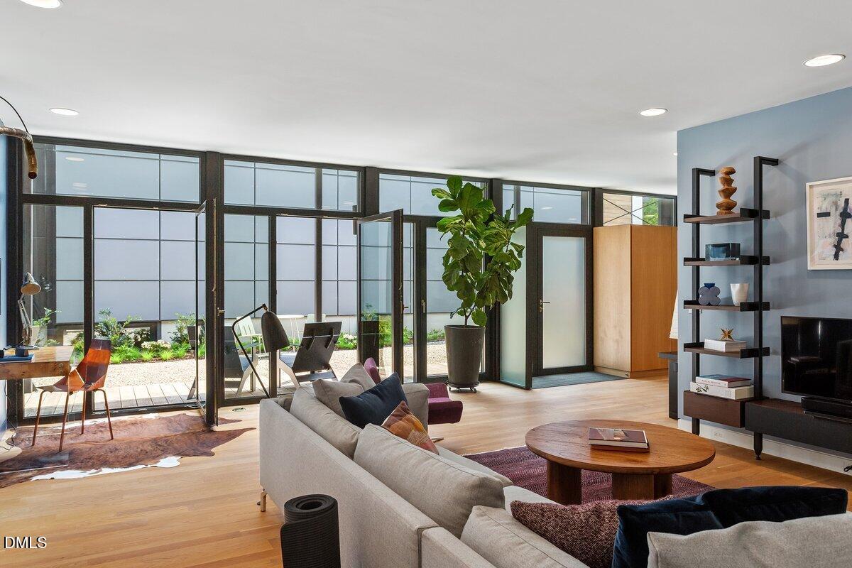 924 Tower Street Raleigh, NC 27607 - Photo 4 of 32 a living room with furniture and a floor to ceiling window