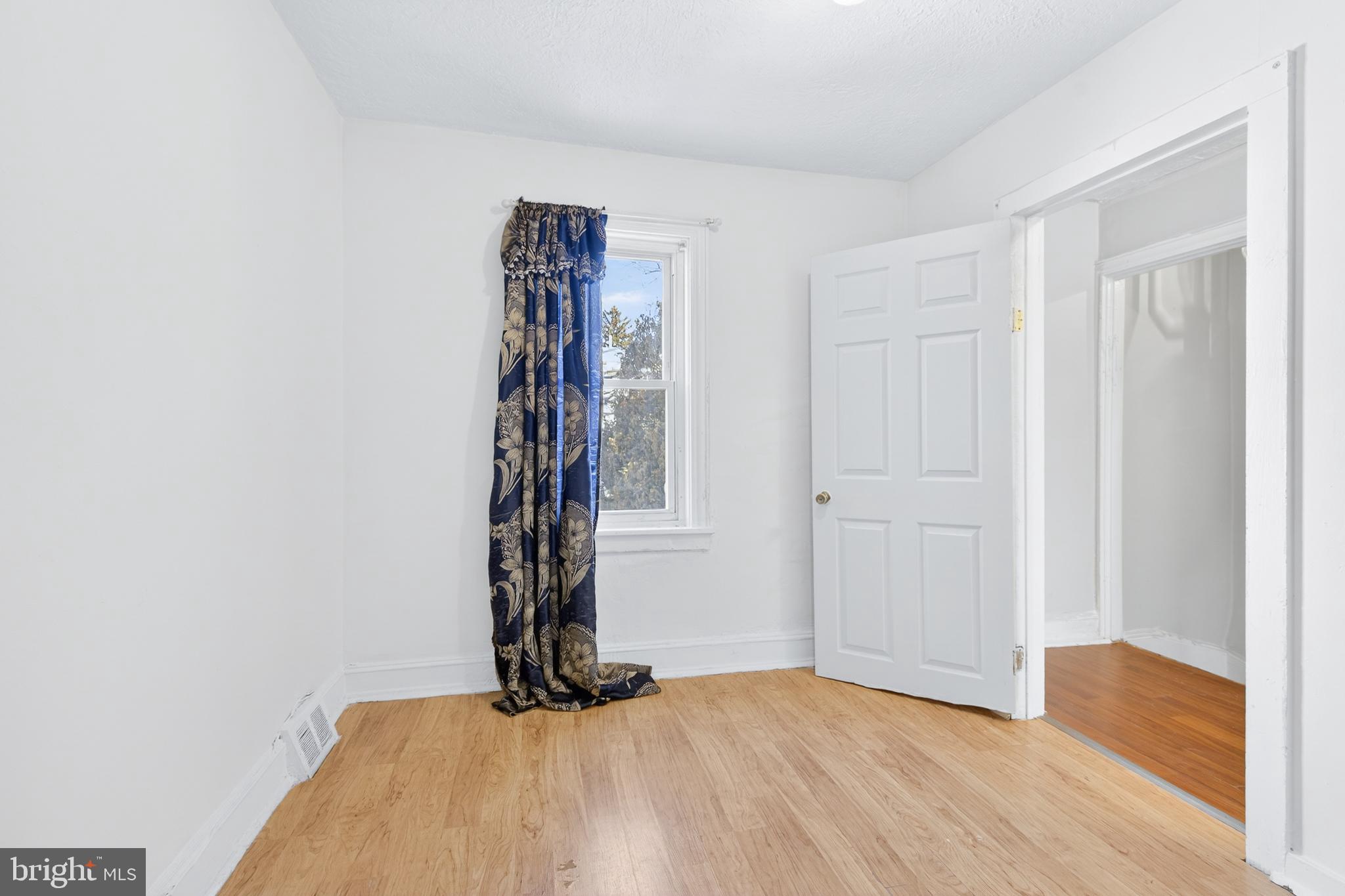 635 1st Street Lancaster, PA 17603 - Photo 14 of 32 a view of an empty room with window and wooden floor