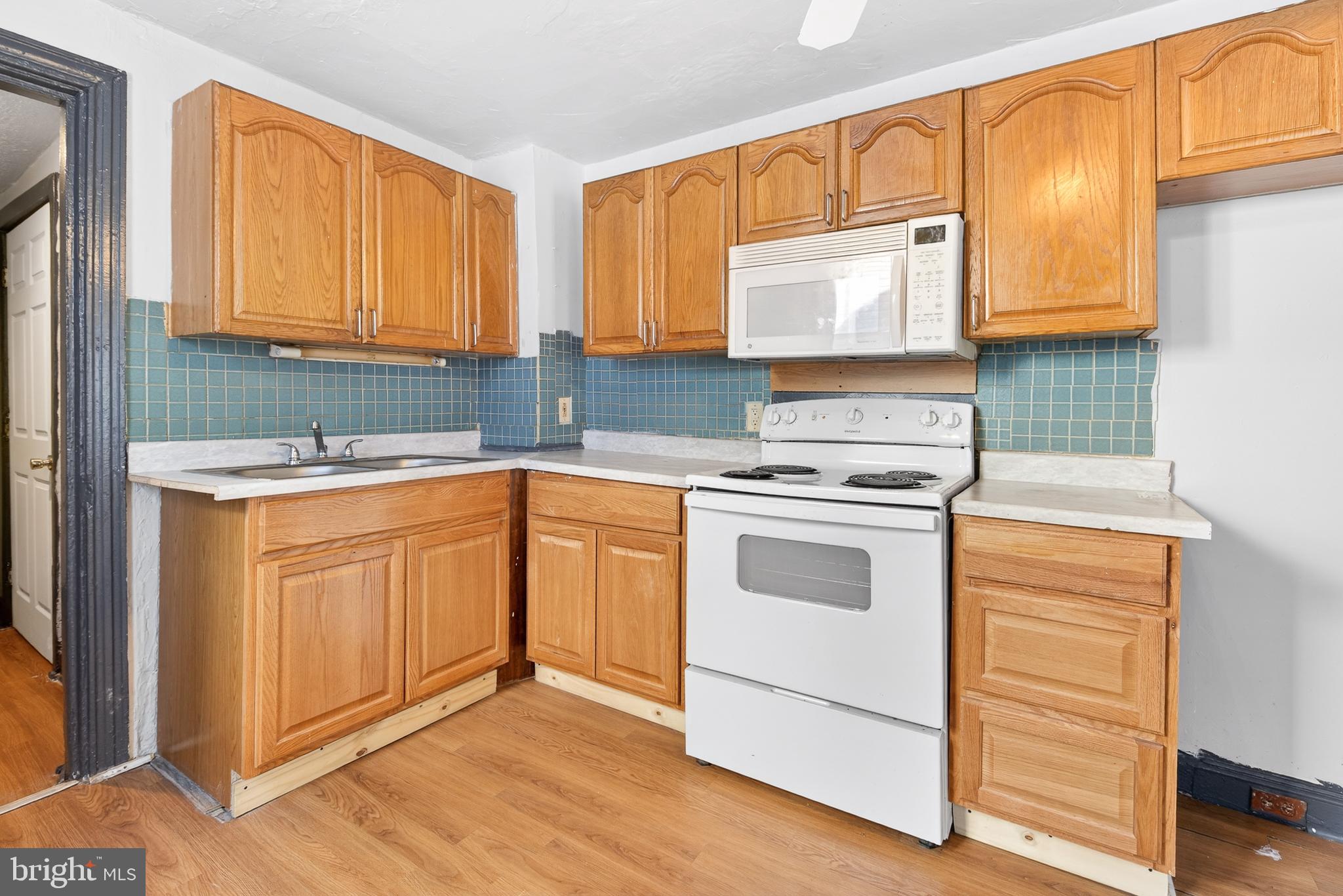 635 1st Street Lancaster, PA 17603 - Photo 8 of 32 a kitchen with granite countertop white cabinets sink and appliances