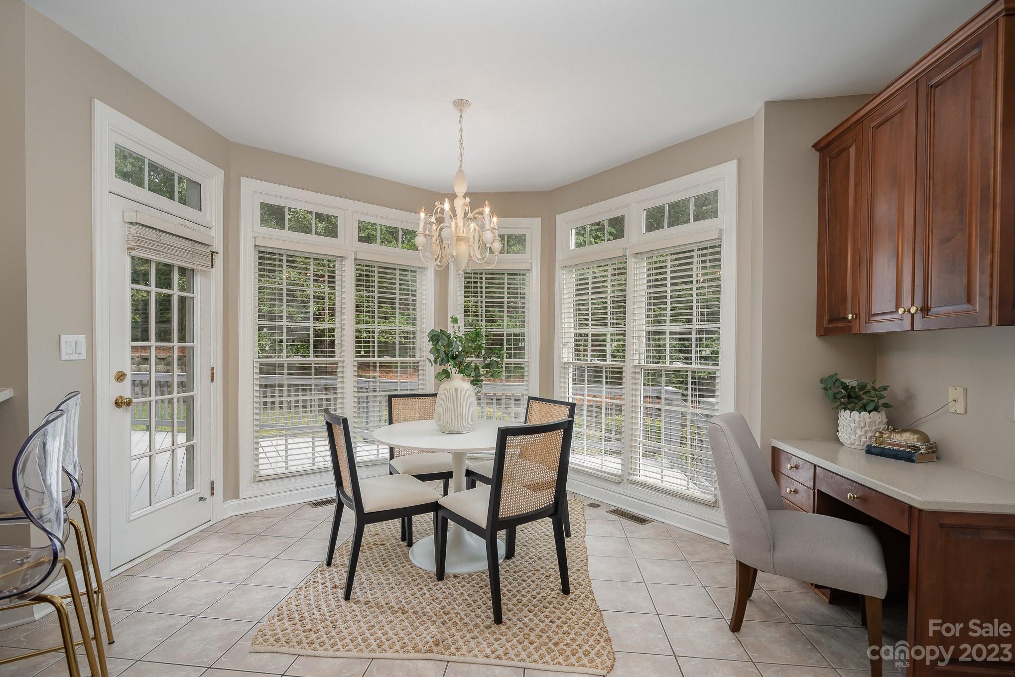 230 Sardis Pointe Road Matthews, NC 28105 - Photo 12 of 42 a dining room with furniture a chandelier and wooden floor