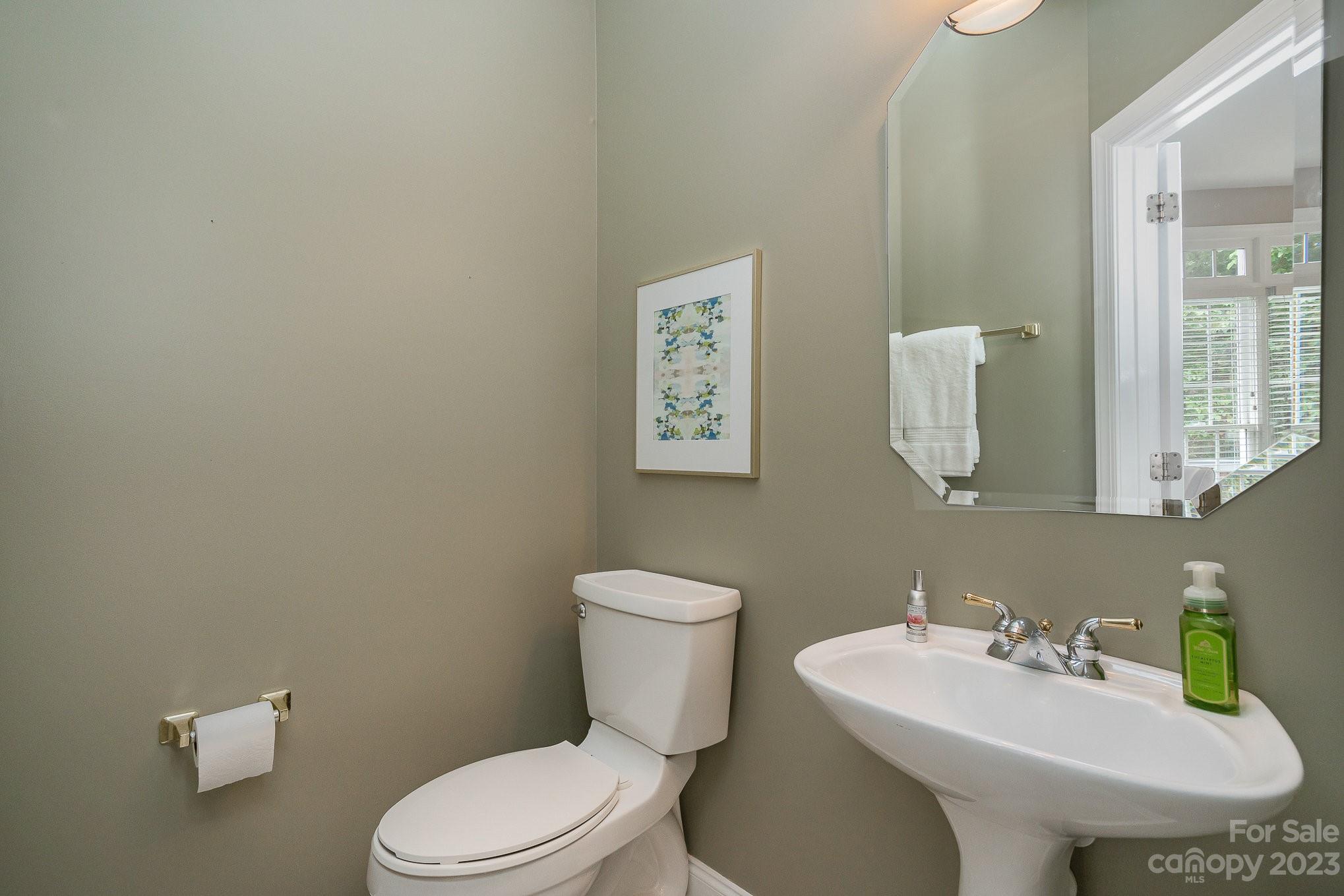 230 Sardis Pointe Road Matthews, NC 28105 - Photo 13 of 42 a bathroom with a toilet sink and mirror