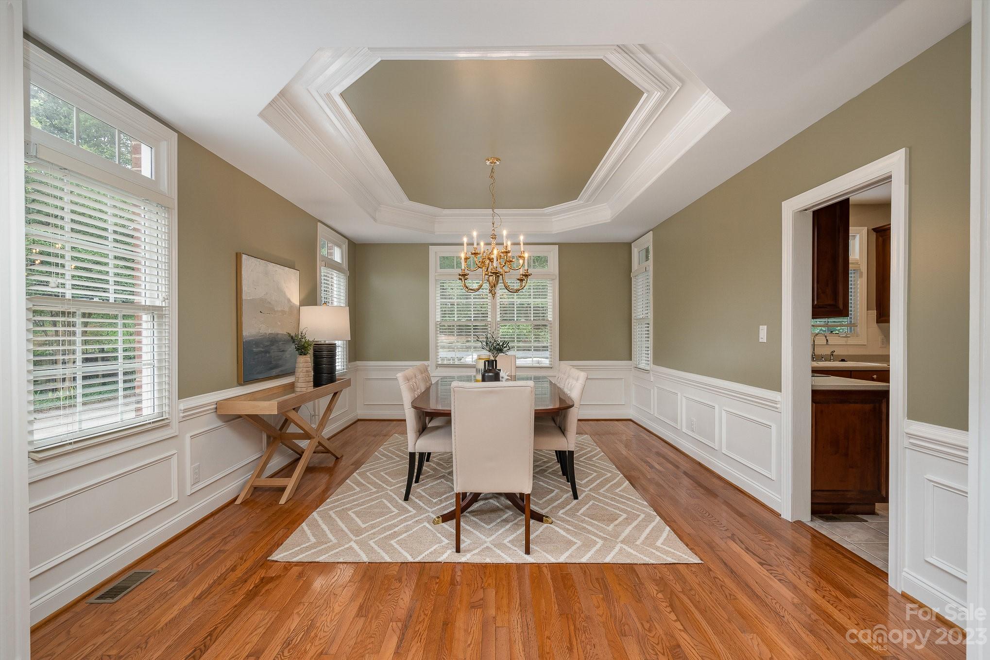230 Sardis Pointe Road Matthews, NC 28105 - Photo 14 of 42 a dining room with wooden floor and a chandelier
