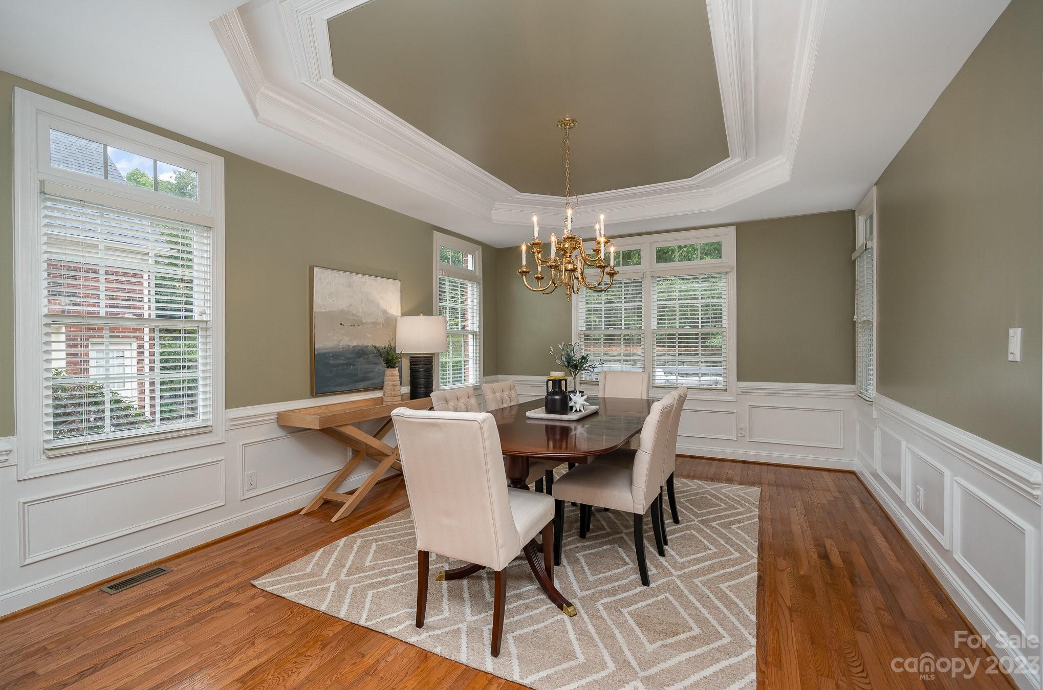 230 Sardis Pointe Road Matthews, NC 28105 - Photo 15 of 42 a dining room with furniture a chandelier and wooden floor