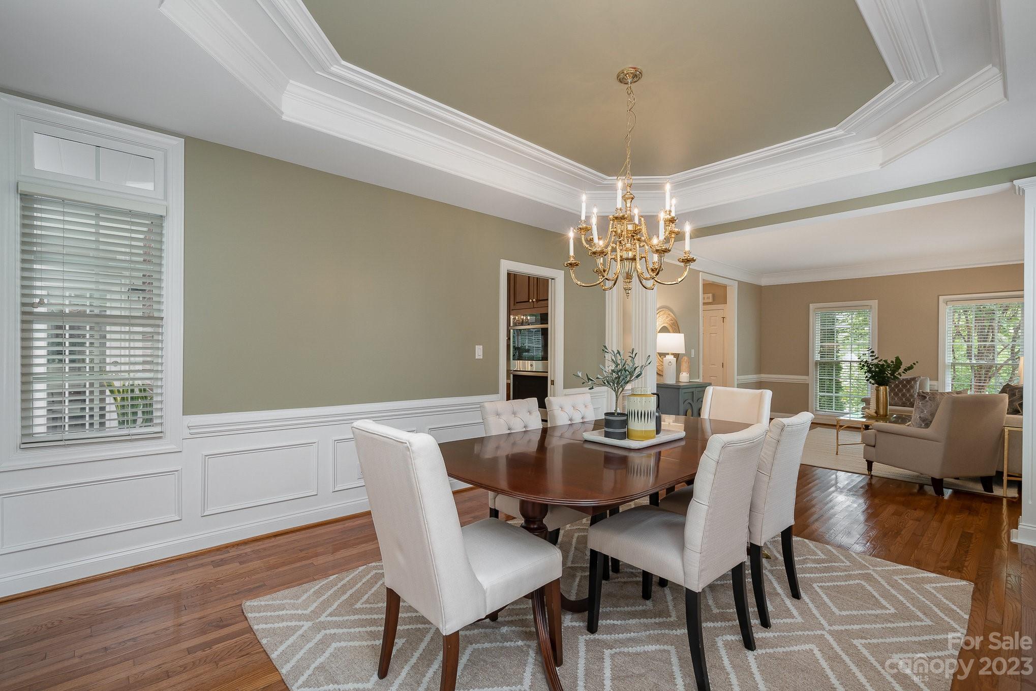 230 Sardis Pointe Road Matthews, NC 28105 - Photo 16 of 42 a dining room with furniture a chandelier and wooden floor