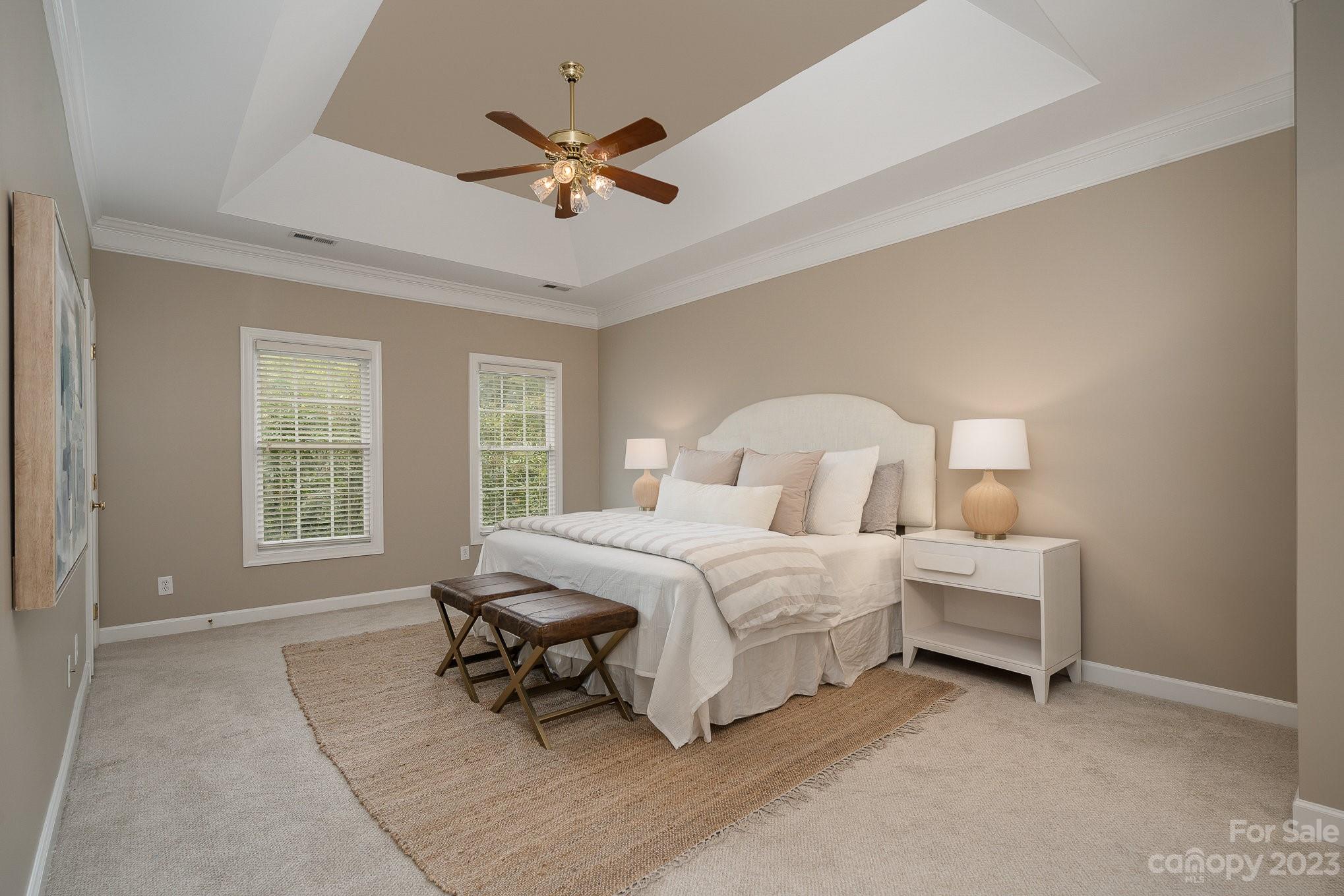 230 Sardis Pointe Road Matthews, NC 28105 - Photo 19 of 42 a bedroom with a bed and a chandelier