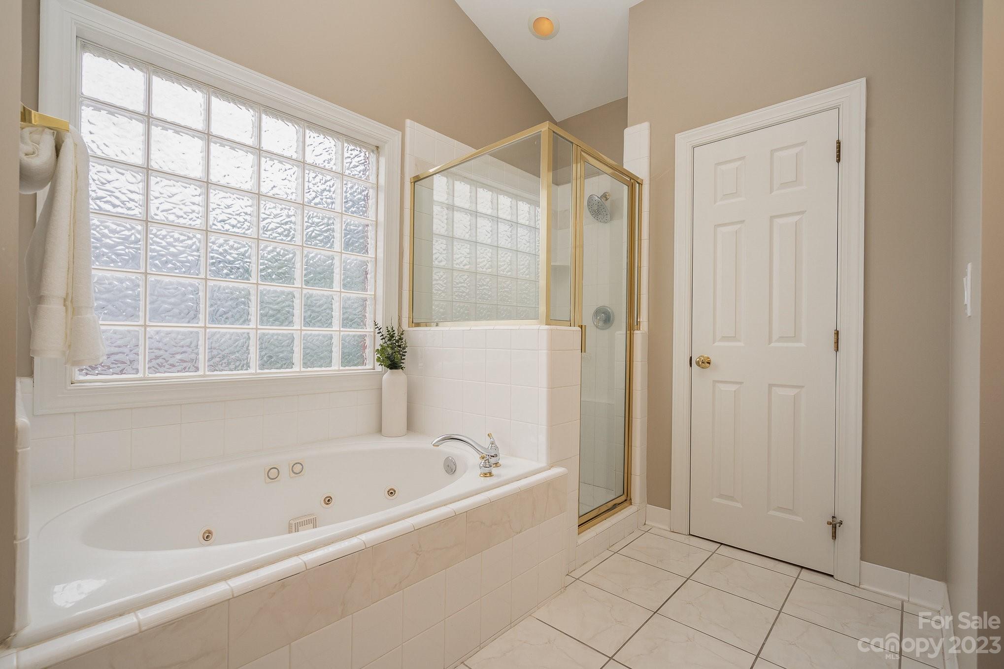 230 Sardis Pointe Road Matthews, NC 28105 - Photo 23 of 42 a bathroom with a bathtub and a shower