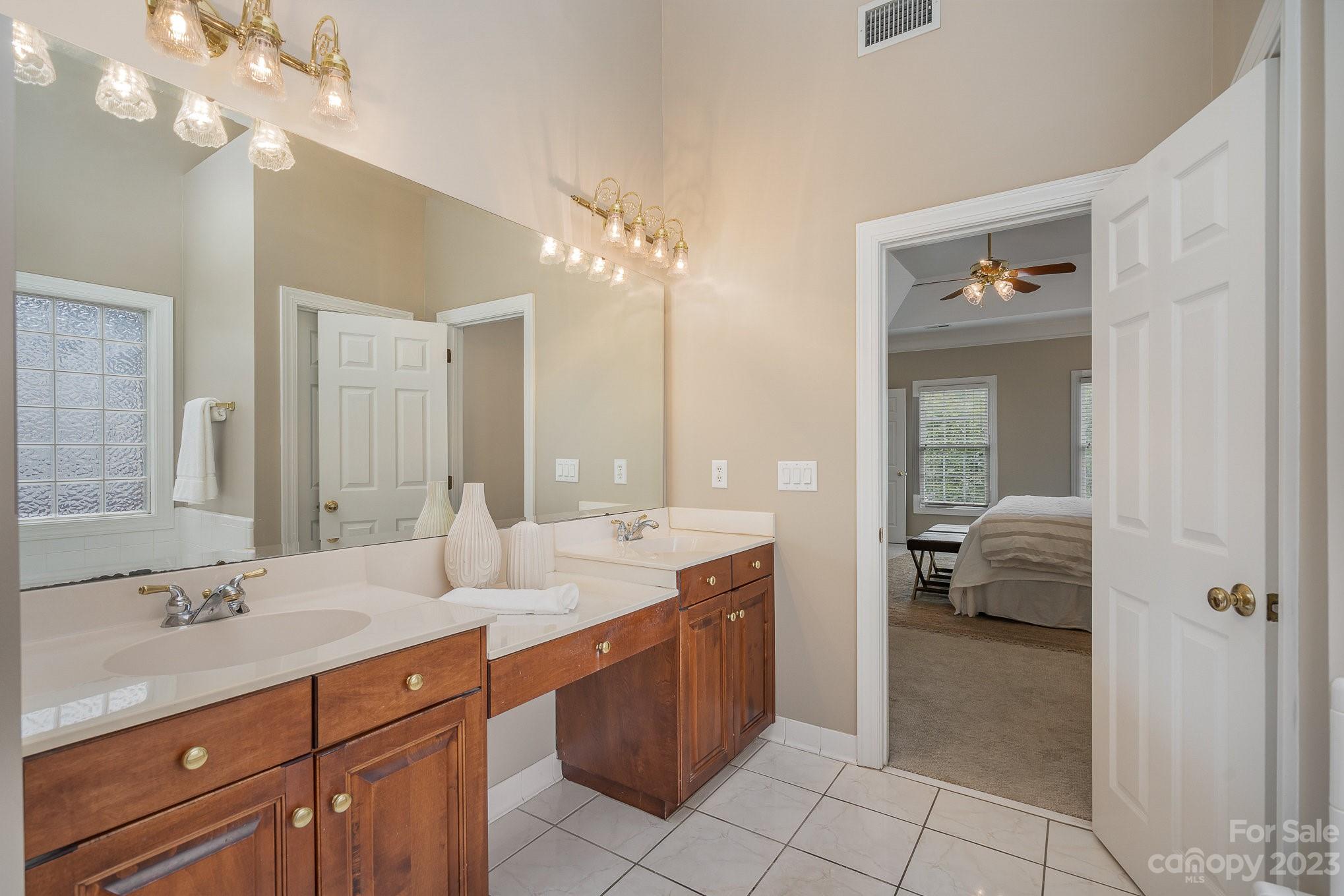 230 Sardis Pointe Road Matthews, NC 28105 - Photo 24 of 42 a en suite bathroom with a double vanity sink a mirror and a shower
