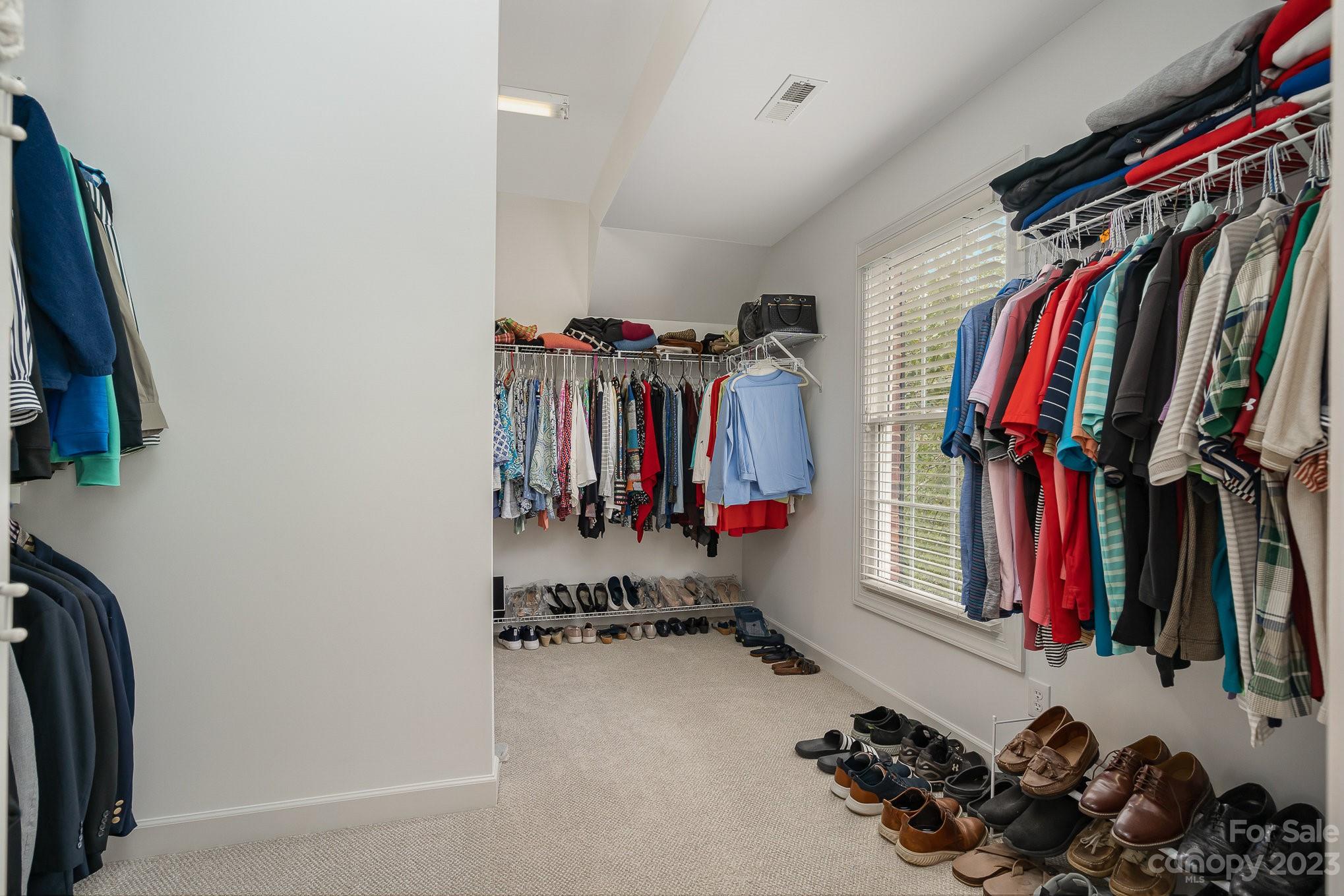 230 Sardis Pointe Road Matthews, NC 28105 - Photo 26 of 42 a view of walk in closet with clothes and shoes