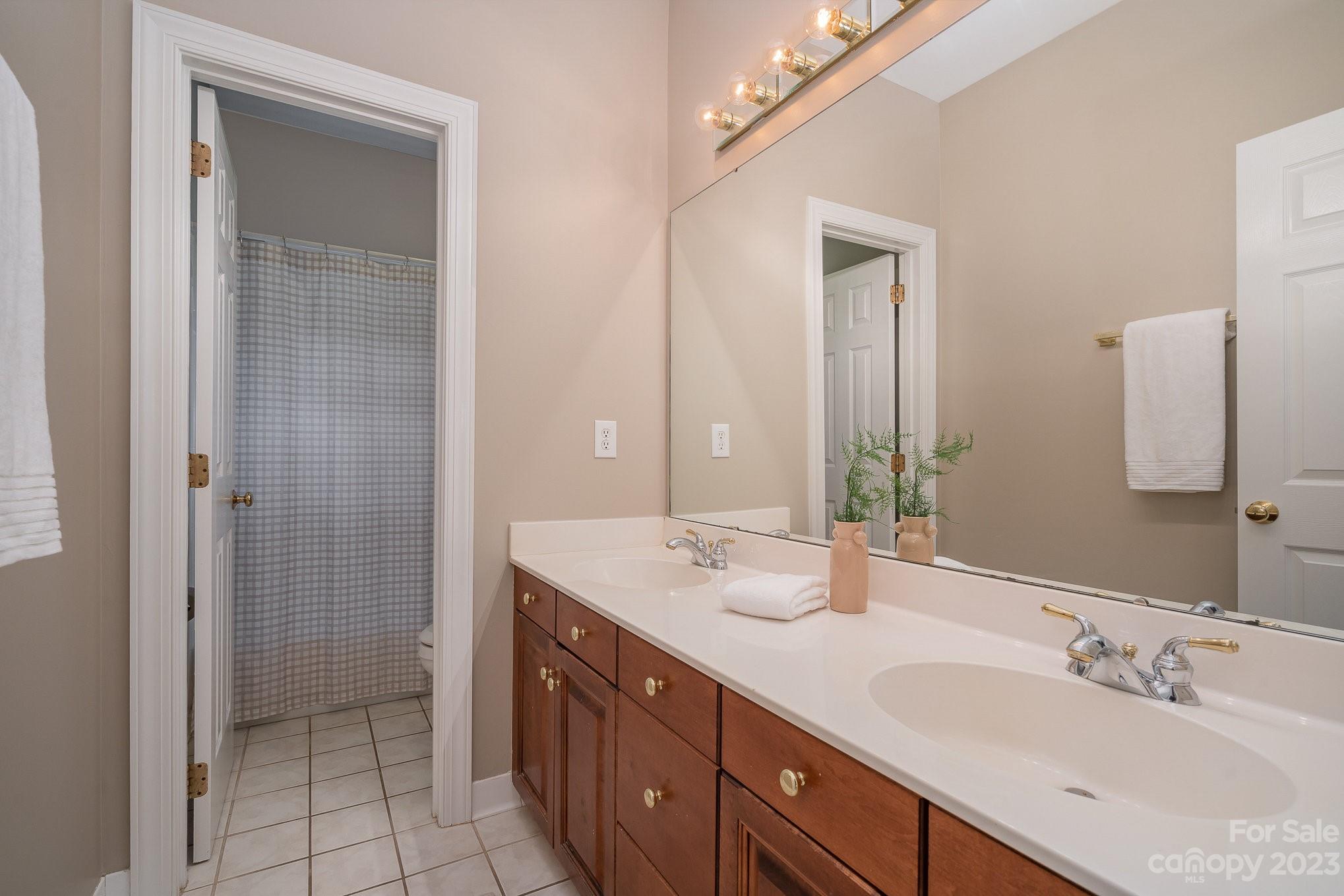 230 Sardis Pointe Road Matthews, NC 28105 - Photo 28 of 42 a bathroom with a double vanity sink mirror and double