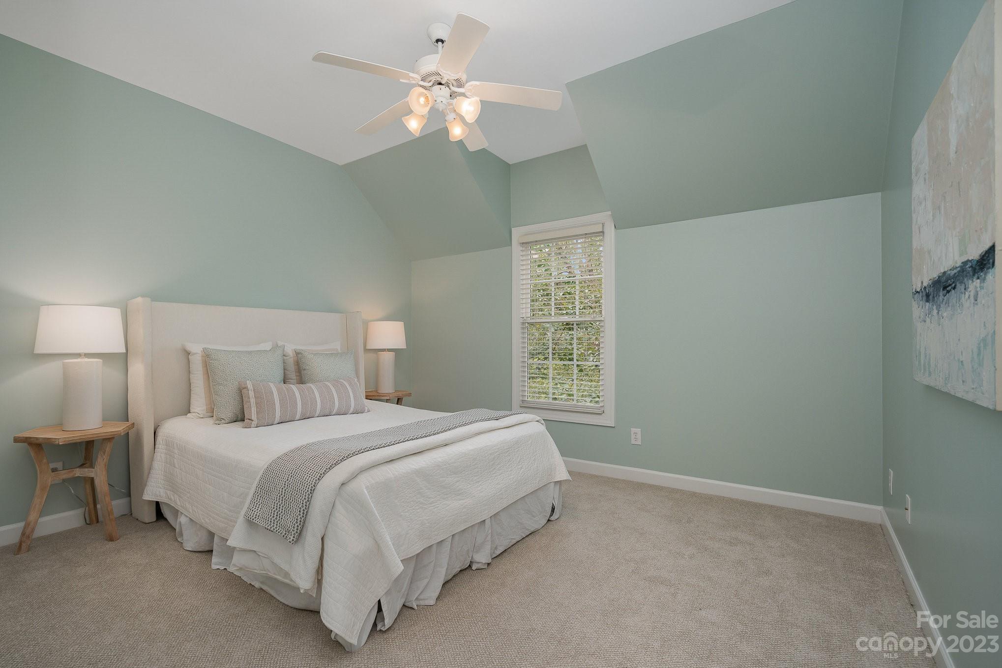230 Sardis Pointe Road Matthews, NC 28105 - Photo 29 of 42 a bedroom with a bed chandelier and a window