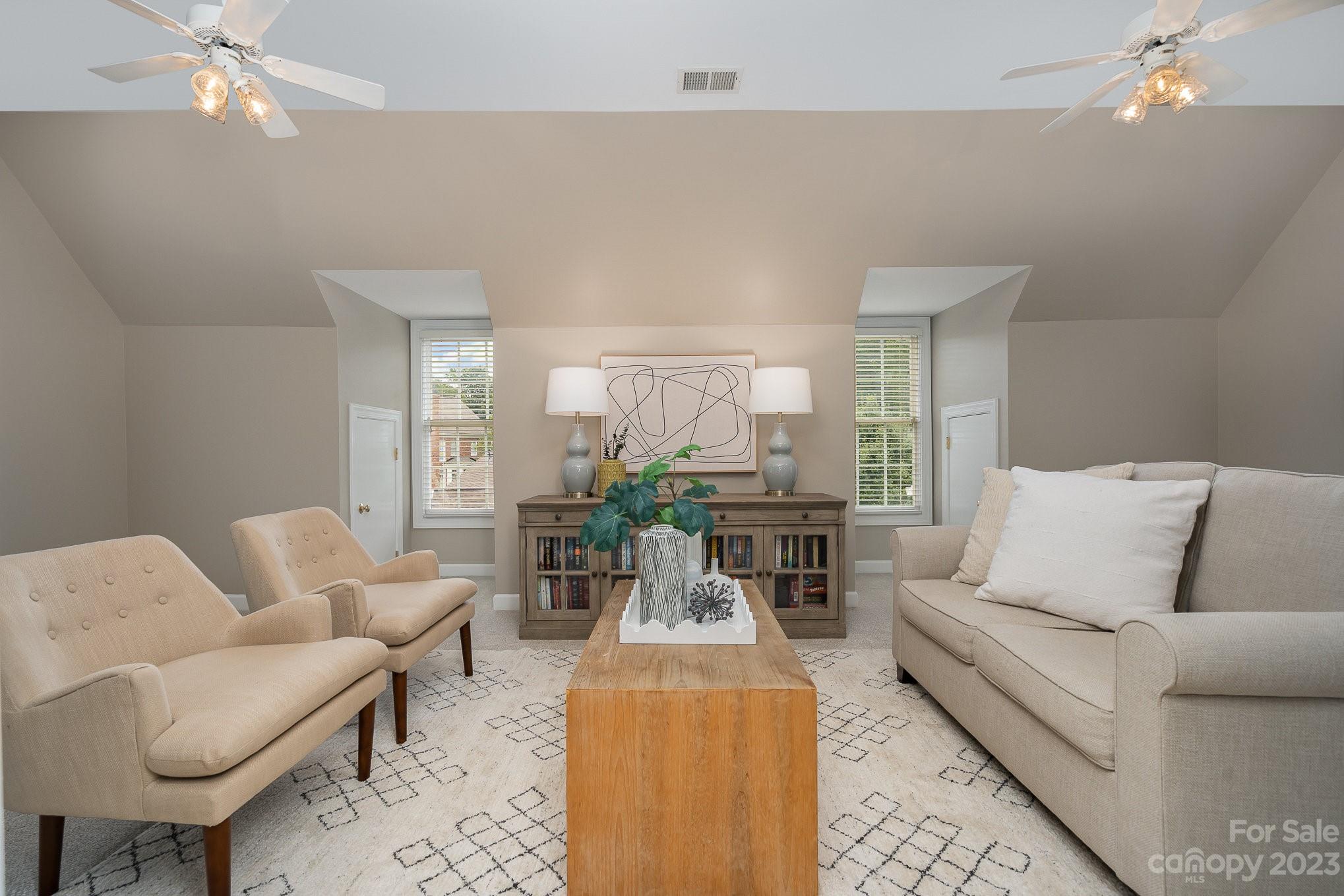 230 Sardis Pointe Road Matthews, NC 28105 - Photo 33 of 42 a living room with furniture and a chandelier