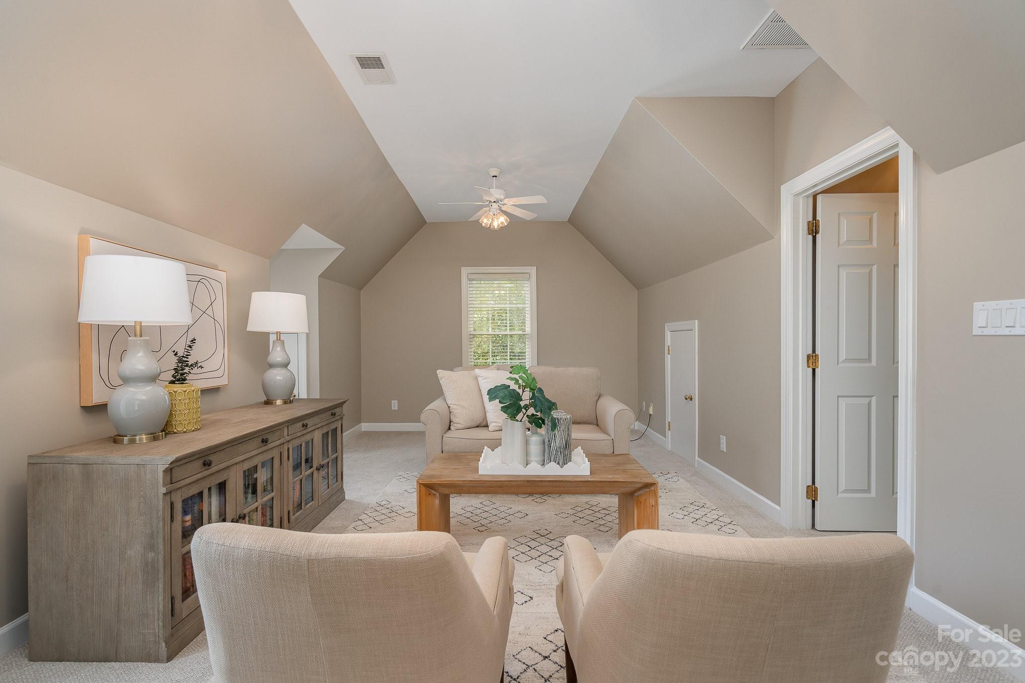 230 Sardis Pointe Road Matthews, NC 28105 - Photo 35 of 42 a living room with furniture and a chandelier