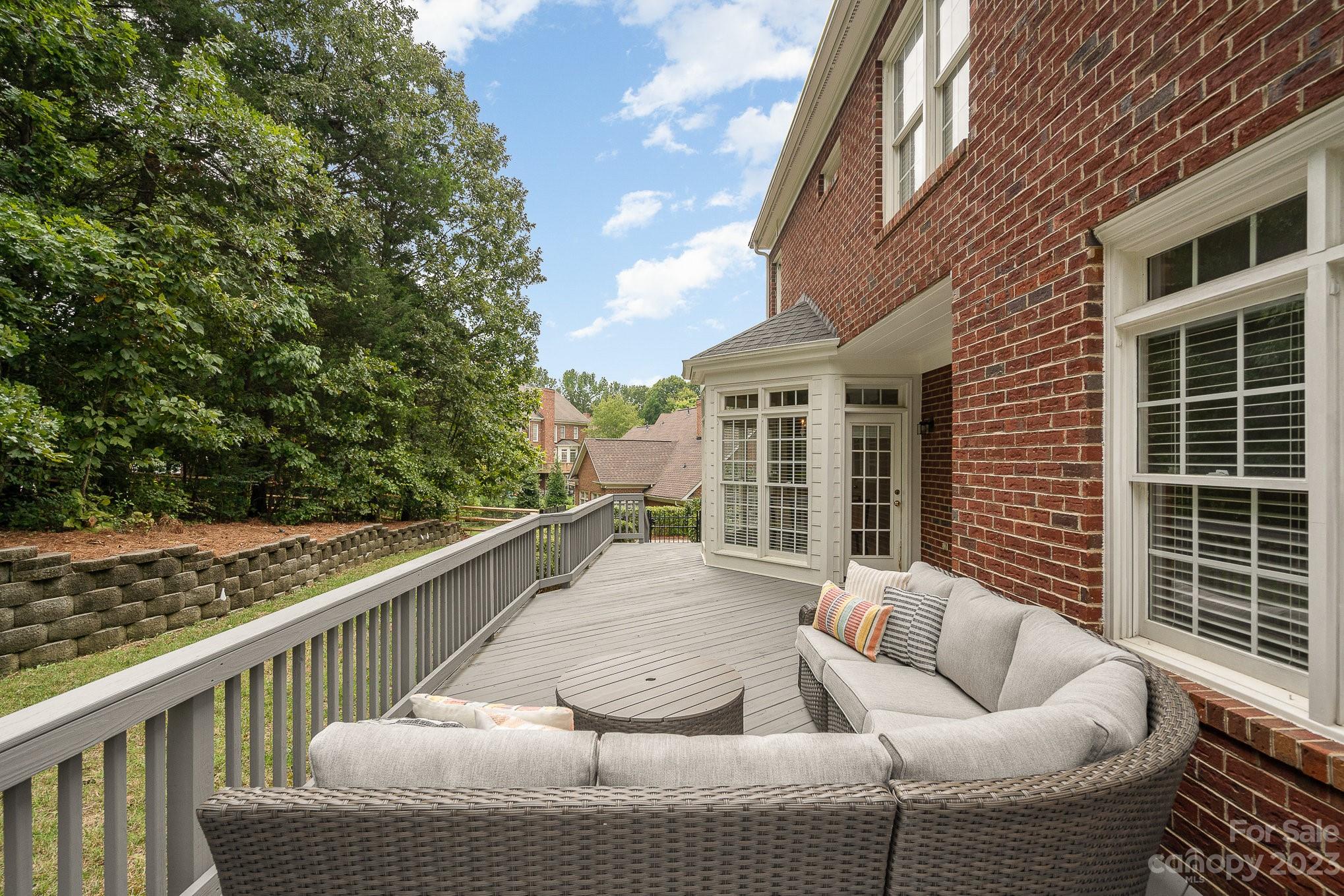 230 Sardis Pointe Road Matthews, NC 28105 - Photo 38 of 42 a view of roof deck with couches and wooden fence