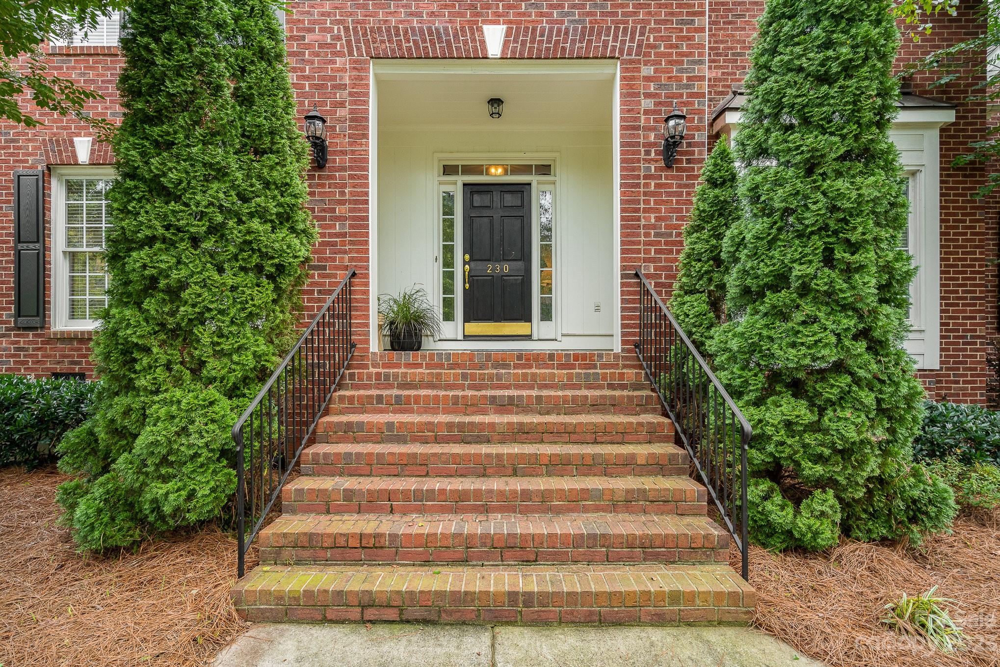 230 Sardis Pointe Road Matthews, NC 28105 - Photo 40 of 42 a front view of a house with plants
