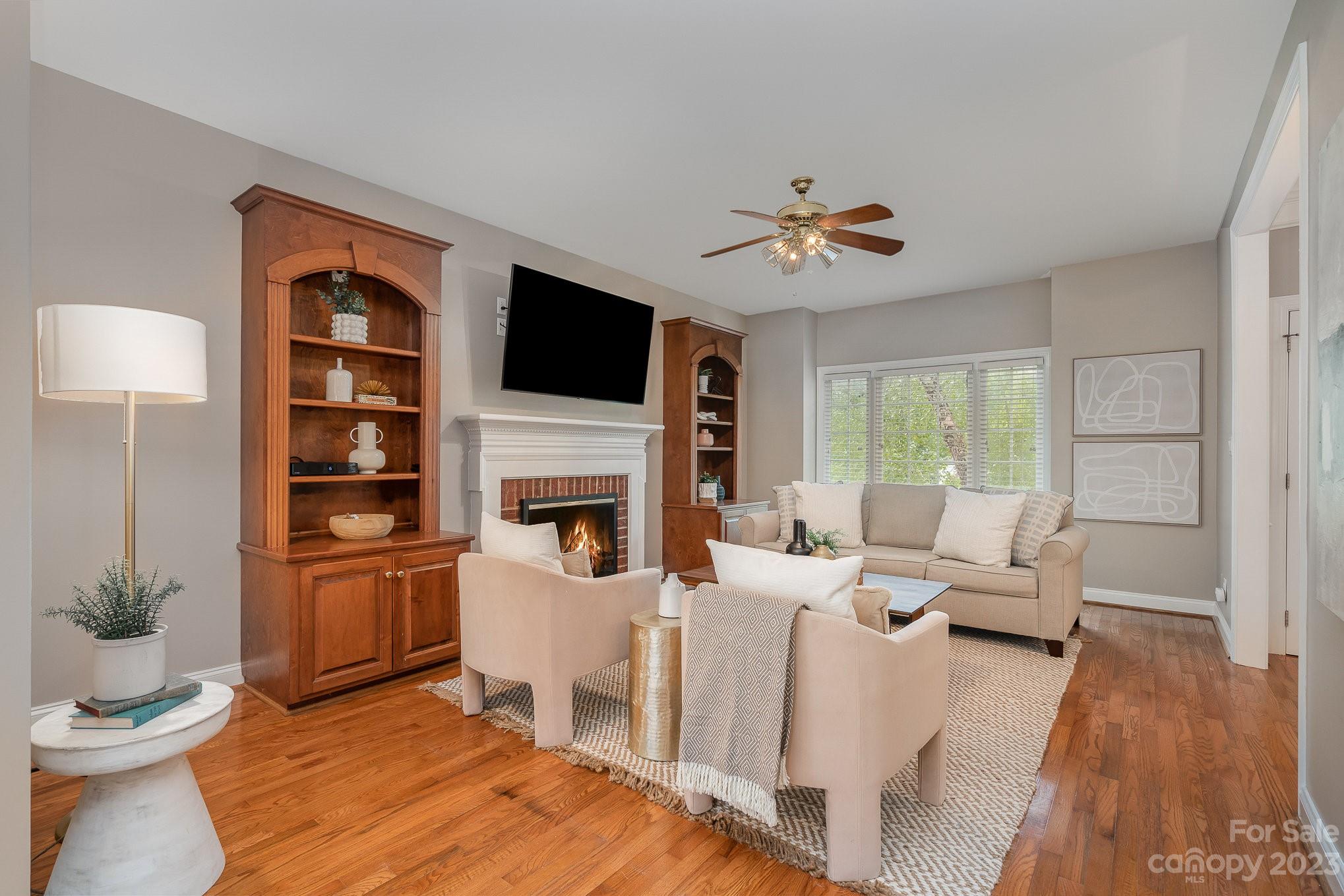 230 Sardis Pointe Road Matthews, NC 28105 - Photo 5 of 42 a living room with furniture a fireplace and a flat screen tv