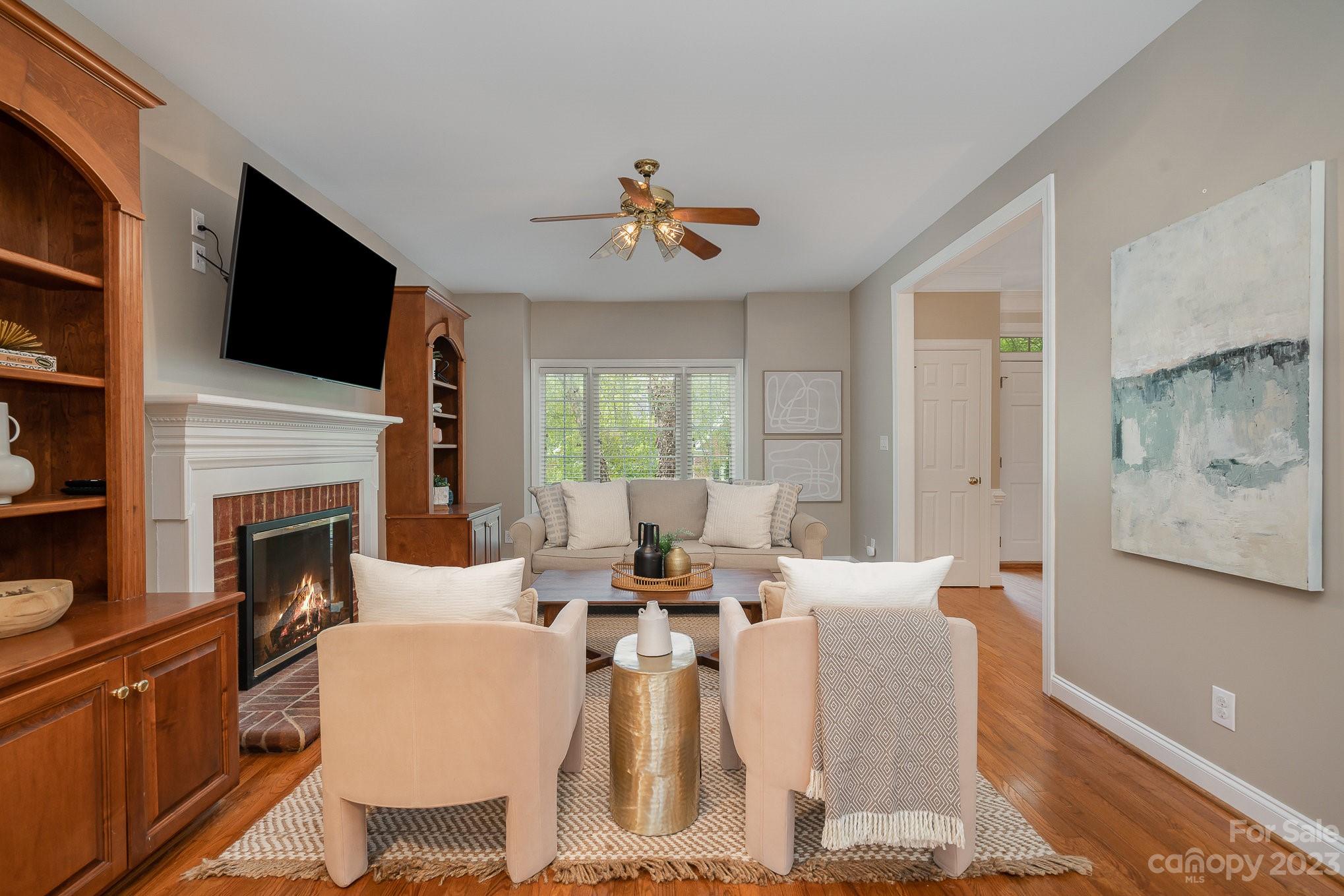 230 Sardis Pointe Road Matthews, NC 28105 - Photo 6 of 42 a living room with furniture a fireplace and a flat screen tv