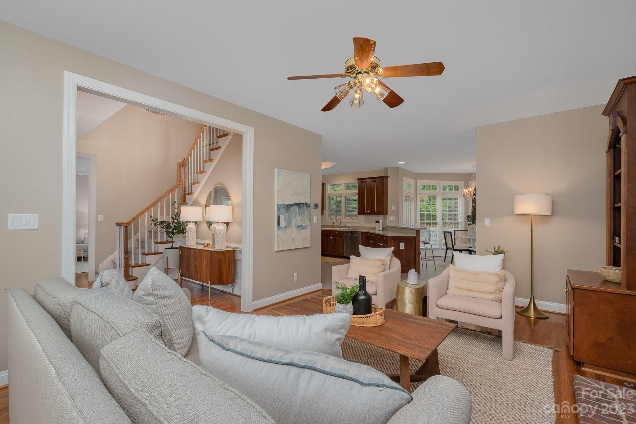 230 Sardis Pointe Road Matthews, NC 28105 - Photo 7 of 42 a living room with furniture and a chandelier